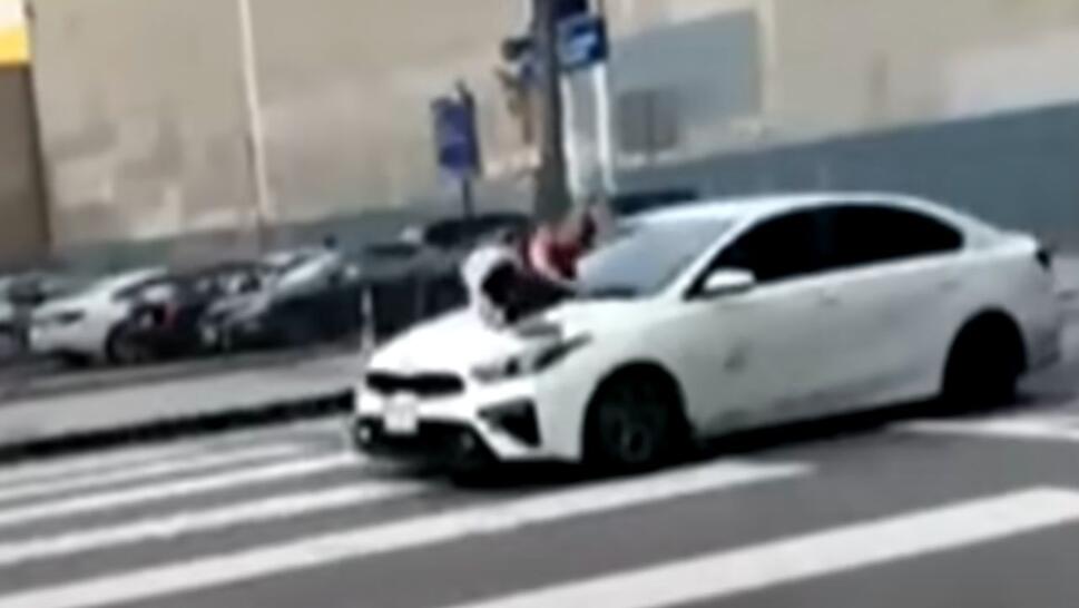 woman on hood of car