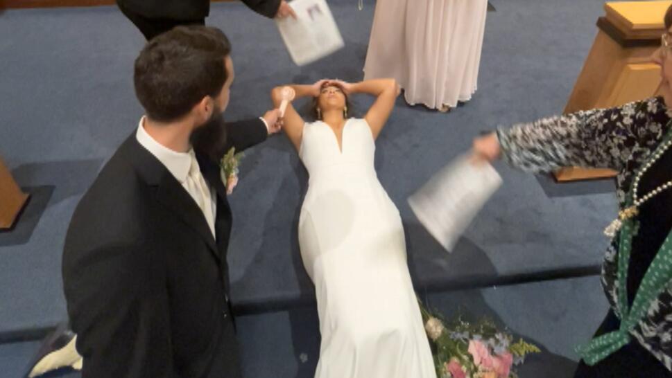 Woman in white dress loses consciousness at altar