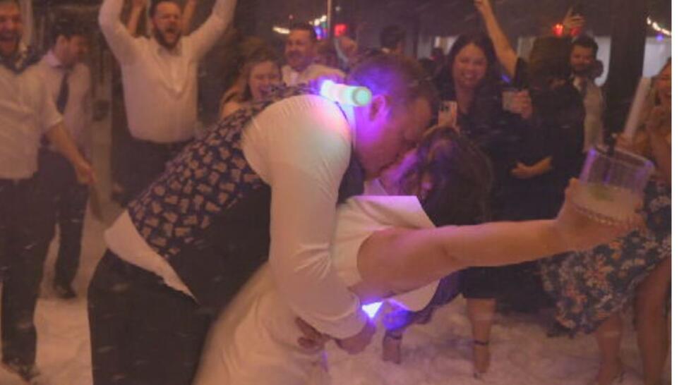 newlyweds Chris and Chloe Nielsen kissing at wedding