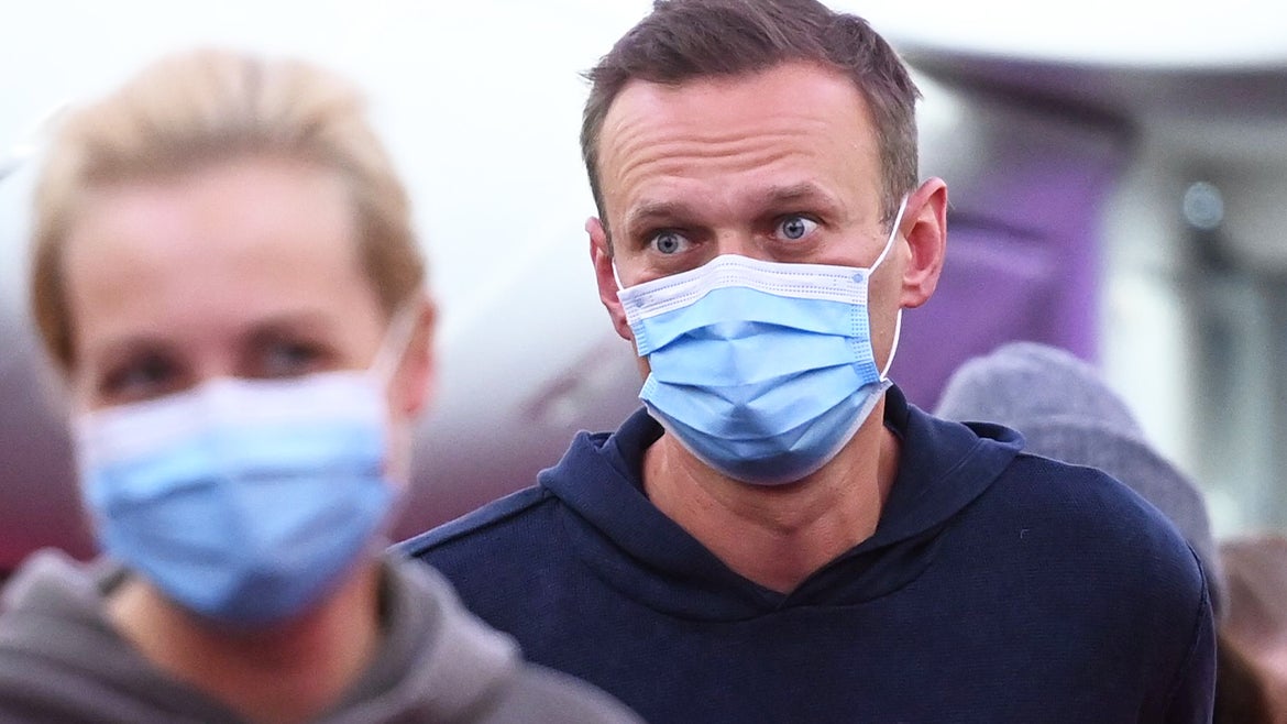 President Vladimir Putin's most vocal critic Alexei Navalny and his wife Yulia are seen disembarking a plane back to Russia in January 2021, six months after Navalny was poisoned. 