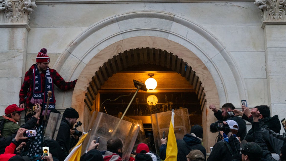 Demonstrators attack law enforcement with furniture in an attempt to enter the U.S. Capitol building during a protest in Washington, D.C., U.S., on Wednesday, Jan. 6, 2021. 