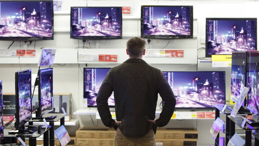 Man in front of TV sets