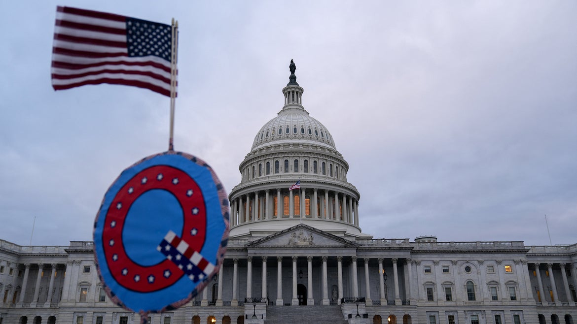 A demonstrator holds a "Q" sign outside the U.S. Capitol in Washington, D.C., U.S., on Wednesday, Jan. 6, 2021