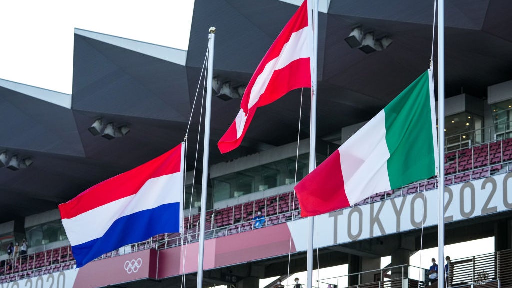 Varied country flags above Tokyo 2020 sign for Olympics