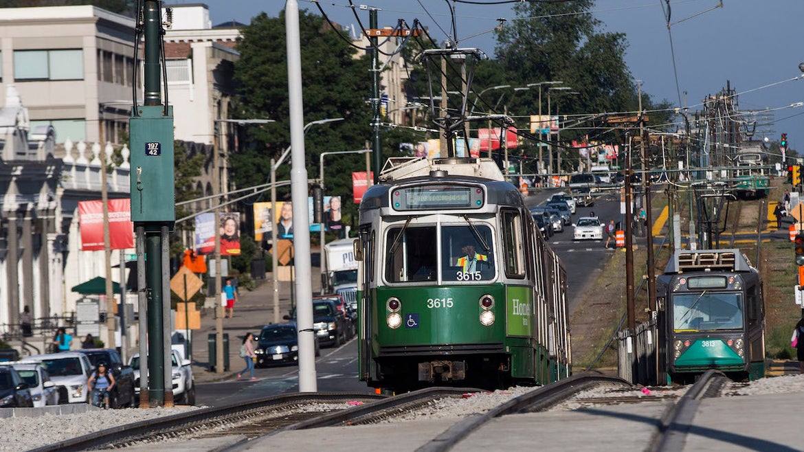Automobile traffic and an MBTA Green Line train move along the Commonwealth Avenue Bridge in Boston as it reopens to traffic on Aug. 16, 2017.