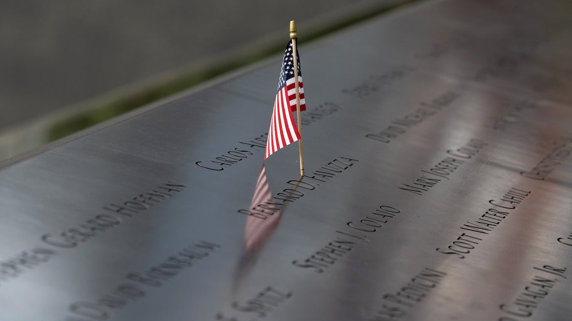 An American flag is seen in a person's name at the North reflecting pool at the 9/11 Memorial Plaza as the city continues Phase 4 of re-opening following restrictions imposed to slow the spread of coronavirus on August 10, 2020 in New York City.