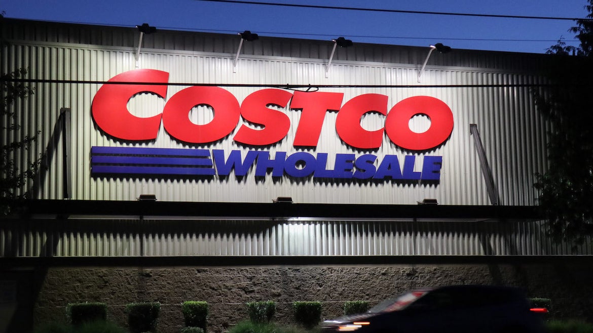 A car passes by a Costco store in Seattle. The American big box retailer is opening new locations in the United States and internationally.