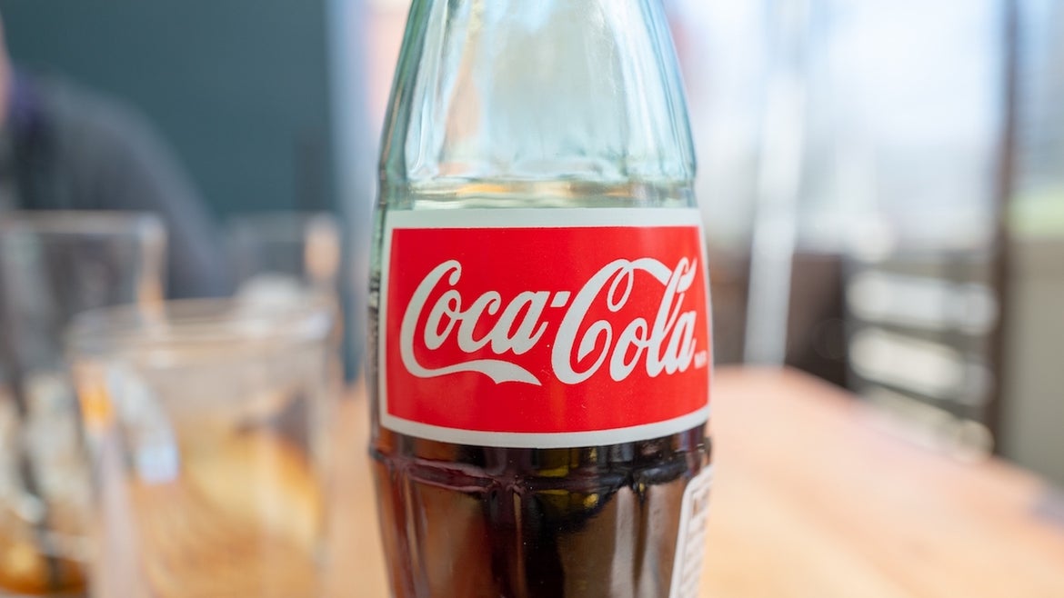Close-up of logo for Coca Cola on glass bottle in a restaurant setting, Walnut Creek, California, March 4, 2021