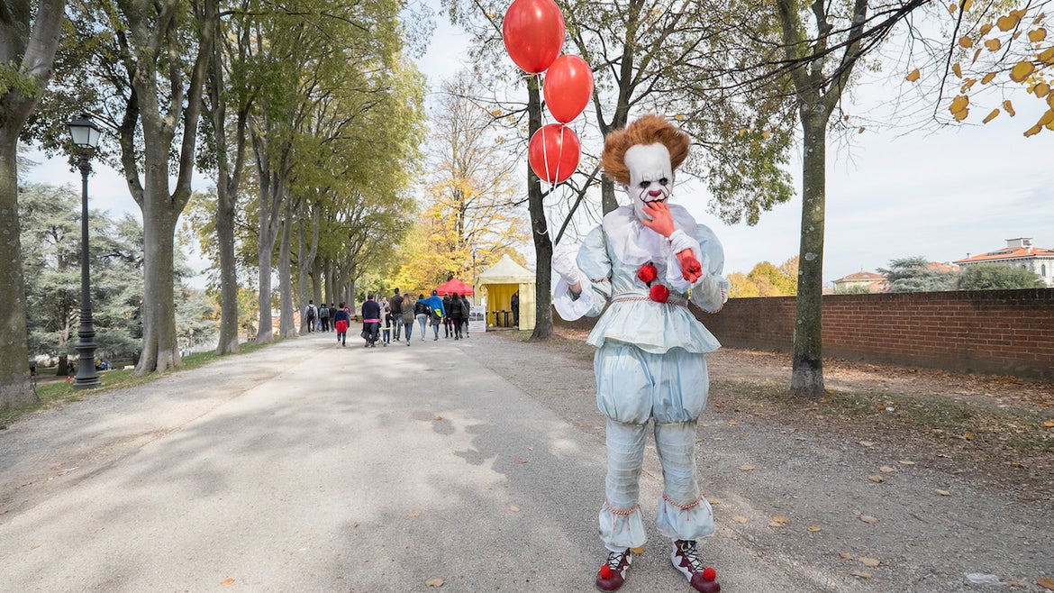  A cosplayer dressed as Pennywise the clown from "It" poses during the opening of the Lucca Comics and Games Heroes on November 2, 2017 in Lucca, Italy
