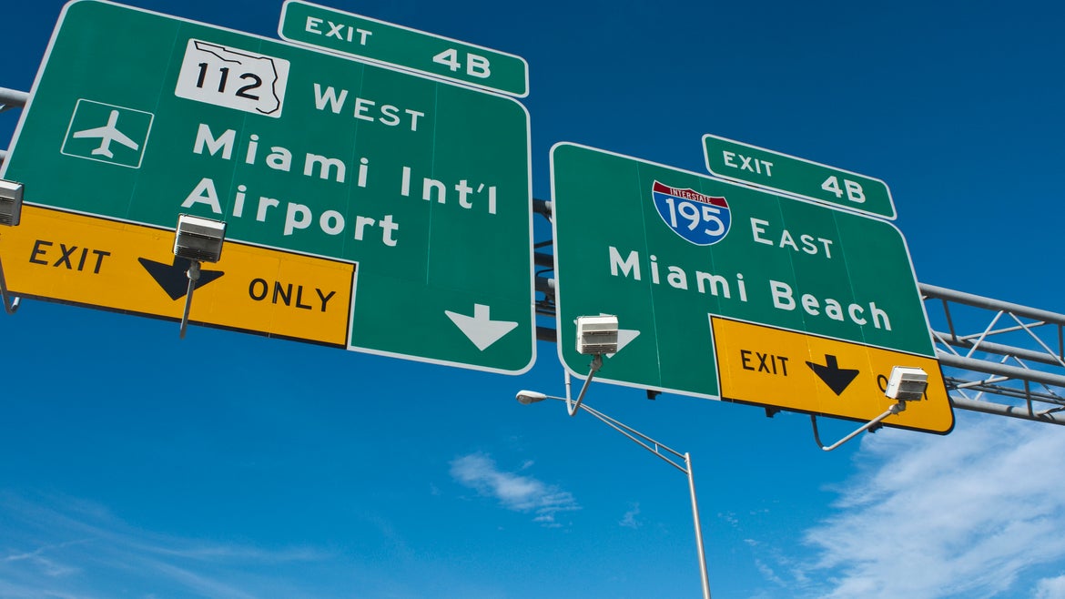 Sign showing Miami Intl Airport and Miami Beach