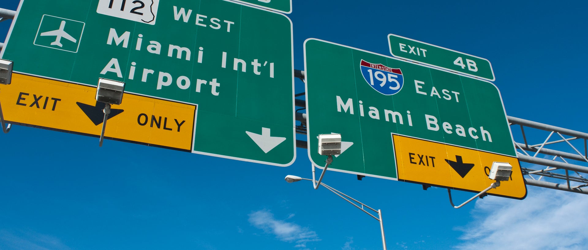 Sign showing Miami Intl Airport and Miami Beach