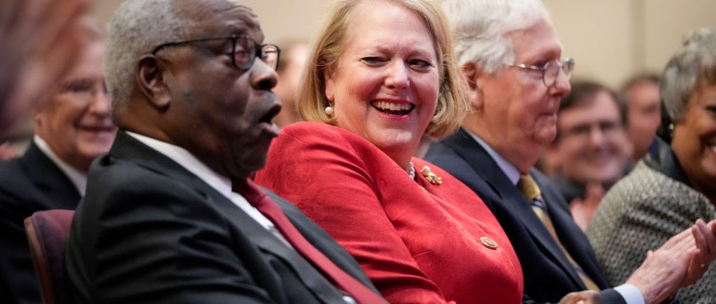 Supreme Court Justice Clarence Thomas, left, appears in a photograph with his wife, Ginni Thomas, right.