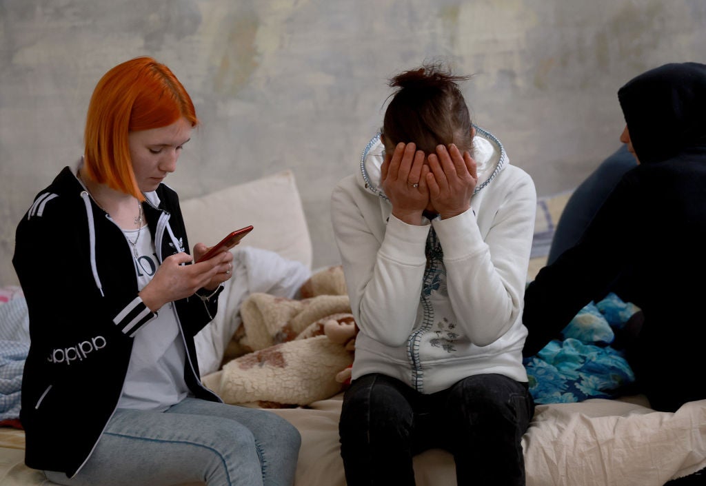 Elena Kravchenko (L) and Yulia Slobudchikova sit on a bed together in a shelter for displaced people after having to flee their hometown of Dnipro on April 04, 2022 in Lviv, Ukraine. Lviv has served as a stopover and shelter for the millions of Ukrainians fleeing the Russian invasion, either to the safety of nearby countries or the relative security of western Ukraine.