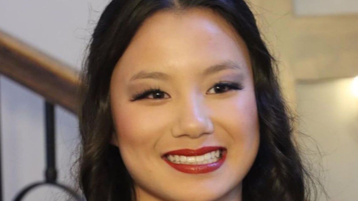 Aleya Brooks smiling, red lipstick, black hair