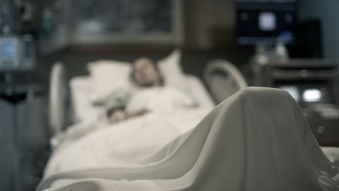 A stock image of a woman in a hospital bed.