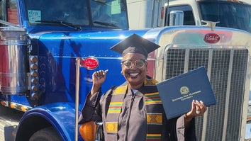 Woman with college diploma in front of truck