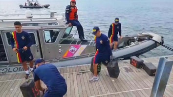Colombian Navy carrying packages off boat