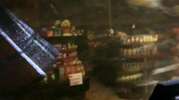 People seek shelter in a gas station during a tornado