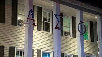 exterior of Alpha Sigma Phi fraternity house at night