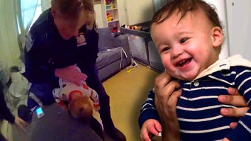 NYPD officer giving Heimlich to baby / Baby smiling