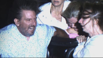 Photo of couple holding onto a girl sitting behind them on a roller coaster