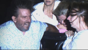 Photo of couple holding onto a girl sitting behind them on a roller coaster