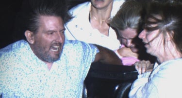 Adults Hold On To Girl In Danger Of Being Swept Out Of Roller Coaster