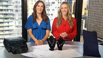 Two women standing behind a table displaying Air Mattress, Necklace, Thermal Set