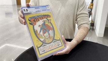 Rare Superman comic being held by seated figure