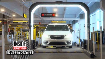 SUV in a parking garage driving through a lit-up arch