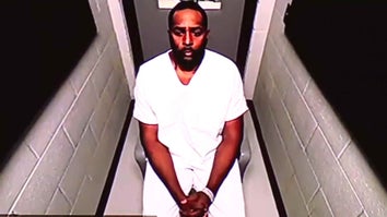 Sherrone Moore in a white jumpsuit wearing cuff as he appears virtually for court