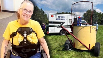 Dena Suihkonen wearing a back brace / Broken dunk tank sitting on grass with an ambulance in the background