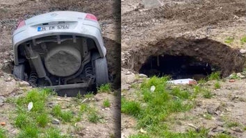 Car disappearing into sinkhole