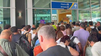 Hundreds of people waiting in an airport
