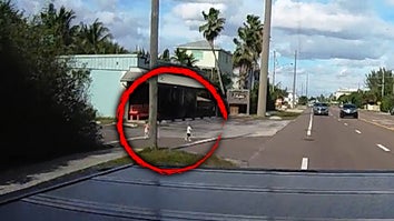 Surveillance footage of two children on a road, within a red circle