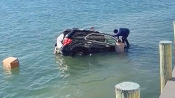 Figure standing on sinking SUV