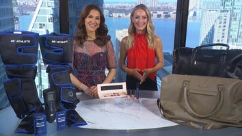Two women standing behind a table displaying a Massager, Makeup Set, Compression Tank Tops Or Shorts