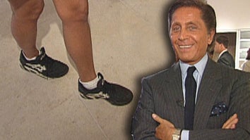 Woman's legs wearing black sneakers / Valentino smiling
