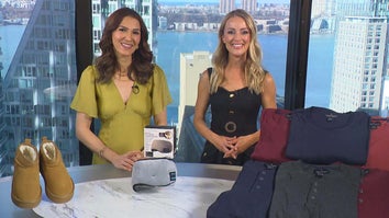 Two women standing behind a table displaying Platform Boots, Sleep Mask, Waffle Shirts
