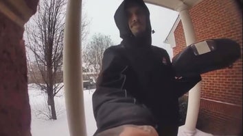 Doorbell security of a man in a winter coat ringing the doorbell while holding a pizza