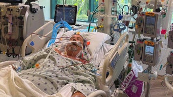 Unconscious man in a hospital bed surrounded by medical machines 