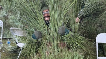An extra dresses as blades of grass at the Super Bowl halftime show