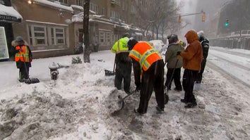 Shovelers Help Clear Snowy Streets 