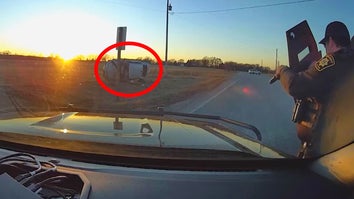 Dashcam video of car flipped on its side, deputy pointing gun from behind a shield