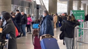 Travelers Stranded at Airports Waiting to Get COVID-19 Tests as Omicron Spreads