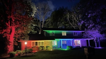 Fachino and Memo home lit by pride colored floodlights