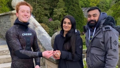 Diver Angus Hosking with Lake District Diving recovers the engagement ring of newly engaged couple Rebecca Chaukria, 26, and her fiancé, Viki Patel, 25