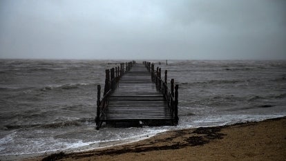 View of a wooden dock under the rain at the beach in Batabano, Mayabeque province, about 60 km south of Havana, on August 27, 2021, as Hurricane Ida passes through eastern Cuba.
