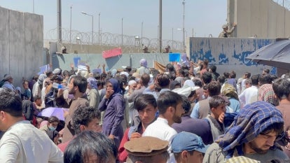 Desperate Afghans try to get on flights at Kabul airport.