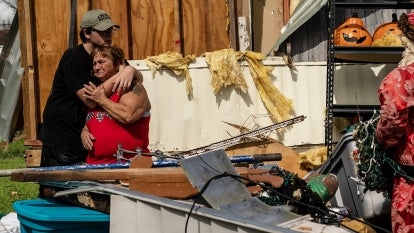 A mother and son embrace after Hurricane Ida tore through their home in Houma.